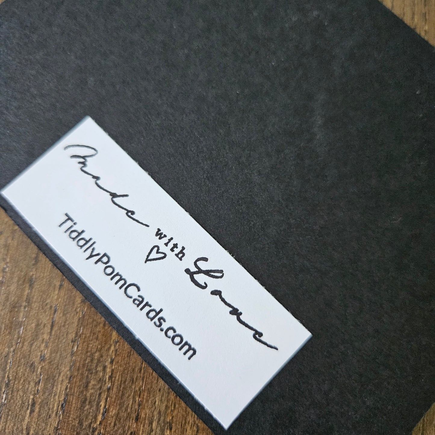 White label with 'Made with Love' text on a dark fabric background