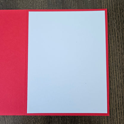 Red card with a white square in the center on a wooden surface