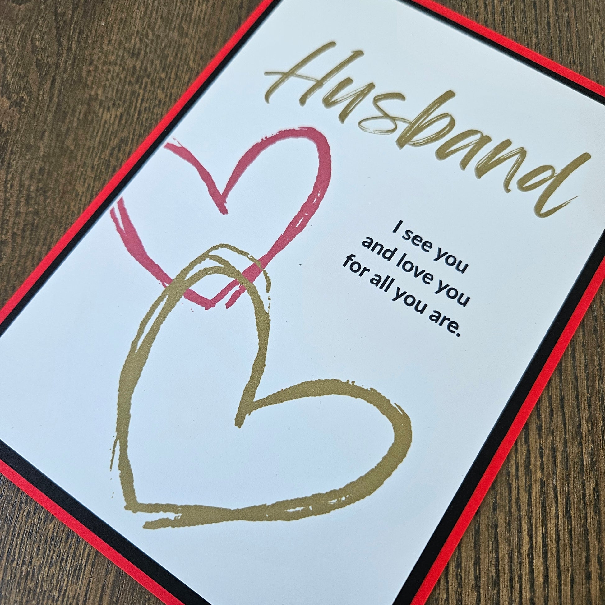 Greeting card for a husband with hearts and text on a wooden surface