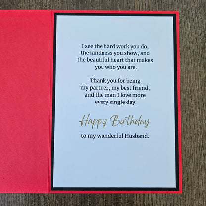 The inside of the handmade birthday card for husband from wife showing a clean white insert with a printed emotional birthday message, framed by a black inner border against a bright red card stock background.