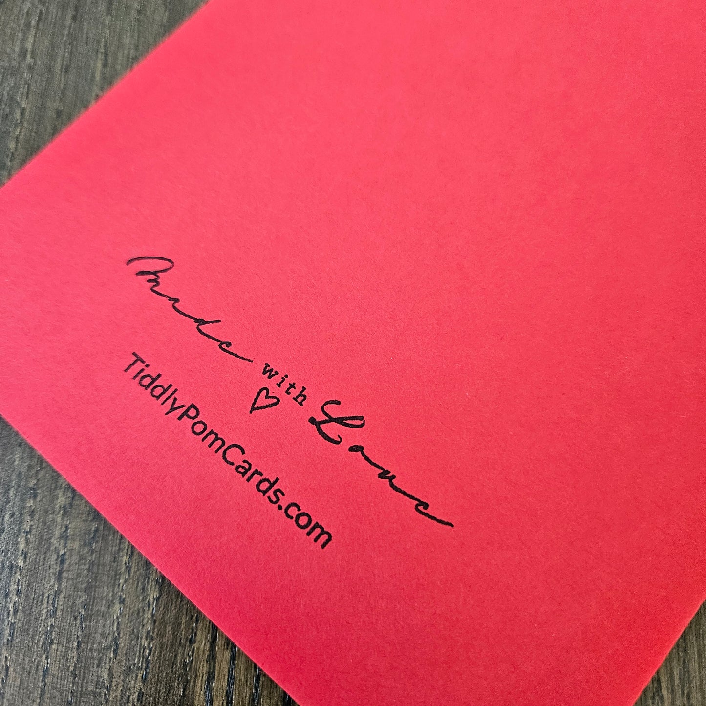 Red card with black text on a wooden surface