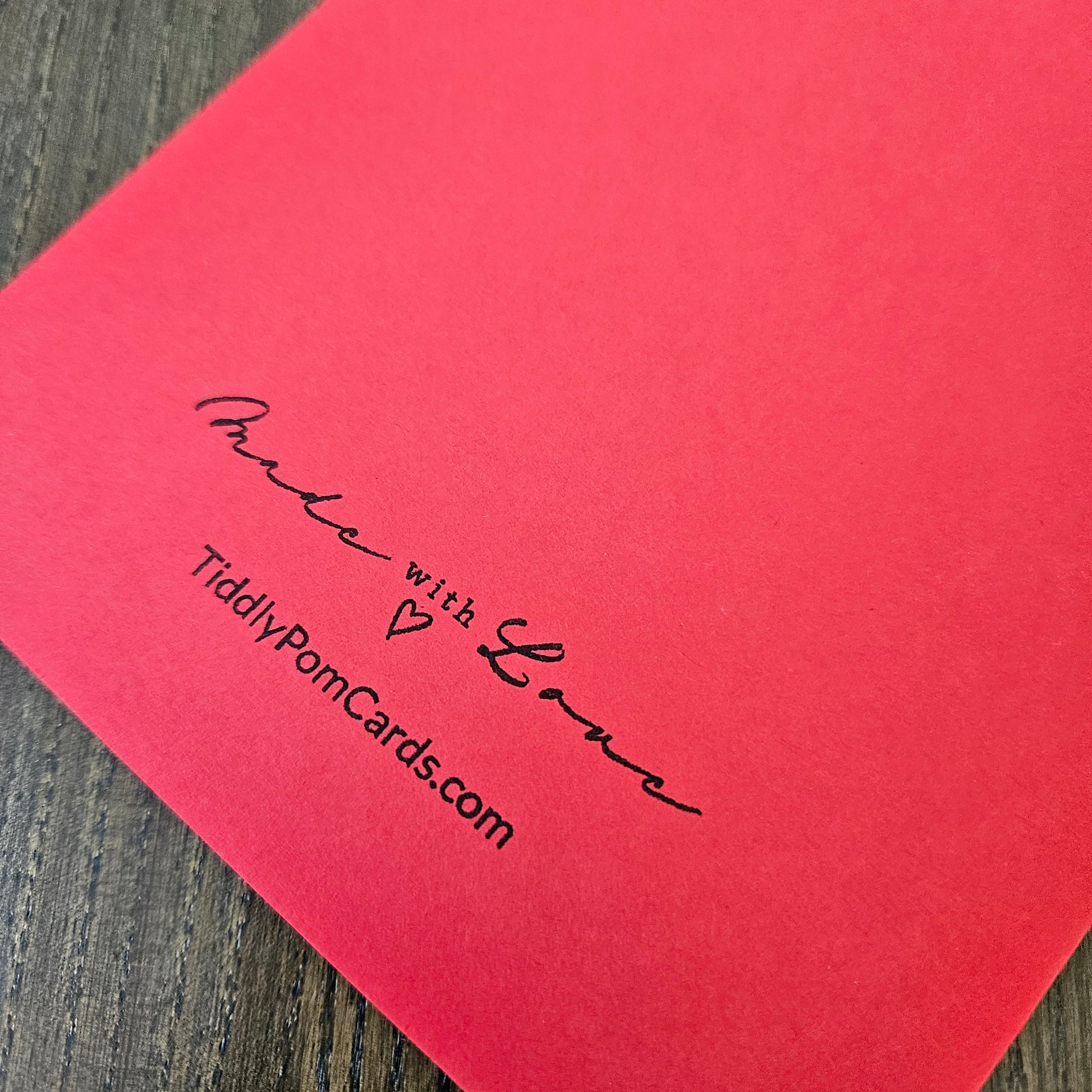 Red card with black text on a wooden surface