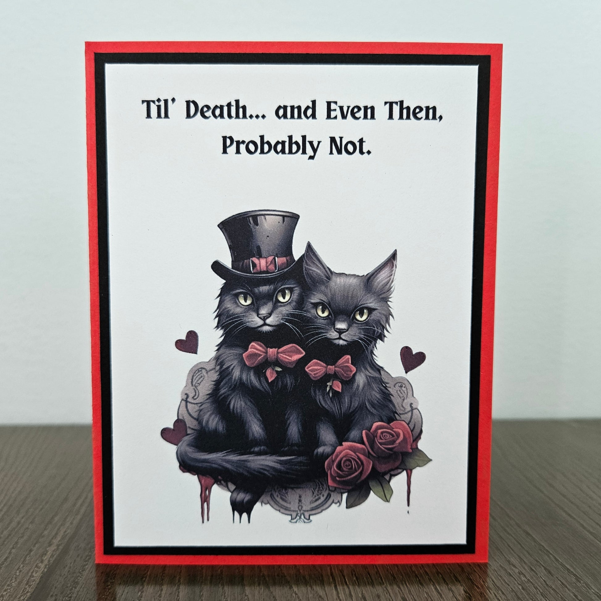 Handmade gothic love card featuring two illustrated black cats with red bows, a top hat, and red roses on a bright red and black layered frame. Text reads Til' Death... and Even Then, Probably Not.