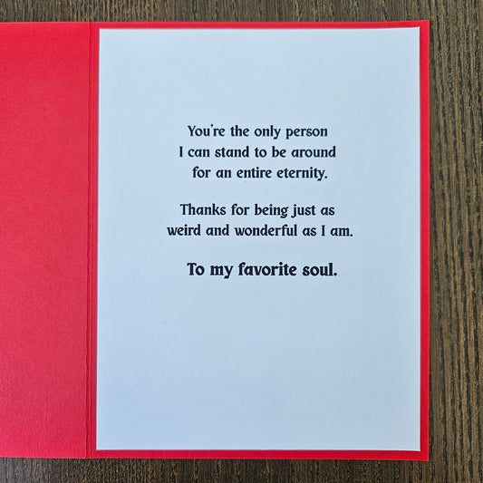 Greeting card with a message on a wooden surface