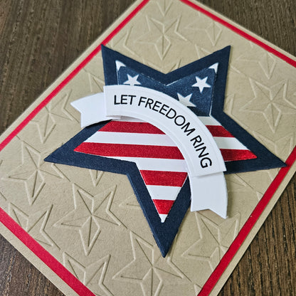 Card with star design and 'Let Freedom Ring' text on a textured surface