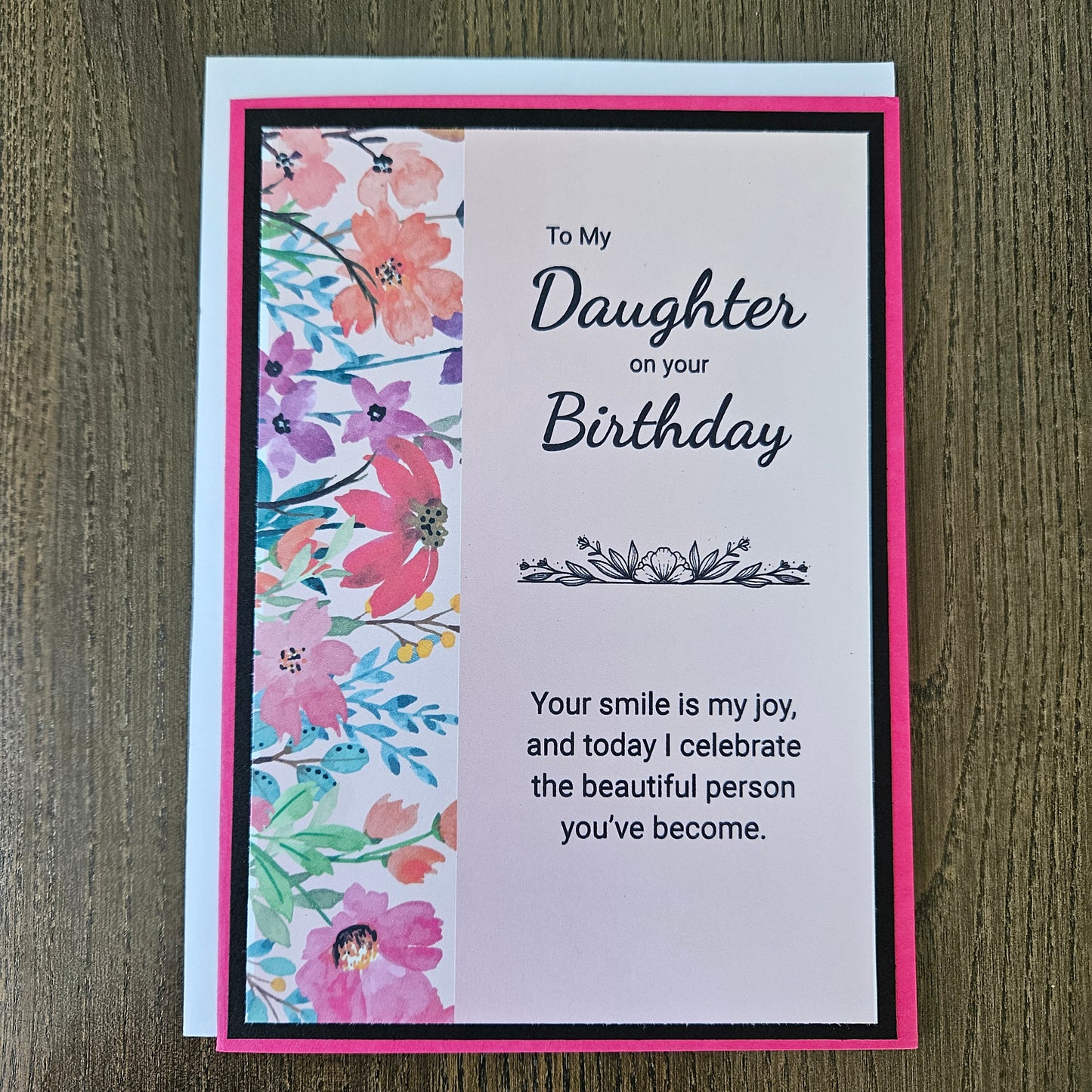a handmade 5x7 birthday card featuring a vibrant watercolor floral split panel design and printed heartfelt sentiments, finished with a crisp black mat and bright pink cardstock frame. Tiddly Pom Cards