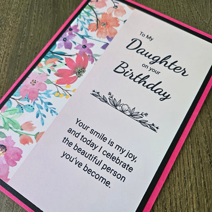 a handmade 5x7 birthday card featuring a vibrant watercolor floral split panel design and printed heartfelt sentiments, finished with a crisp black mat and bright pink cardstock frame. Tiddly Pom Cards