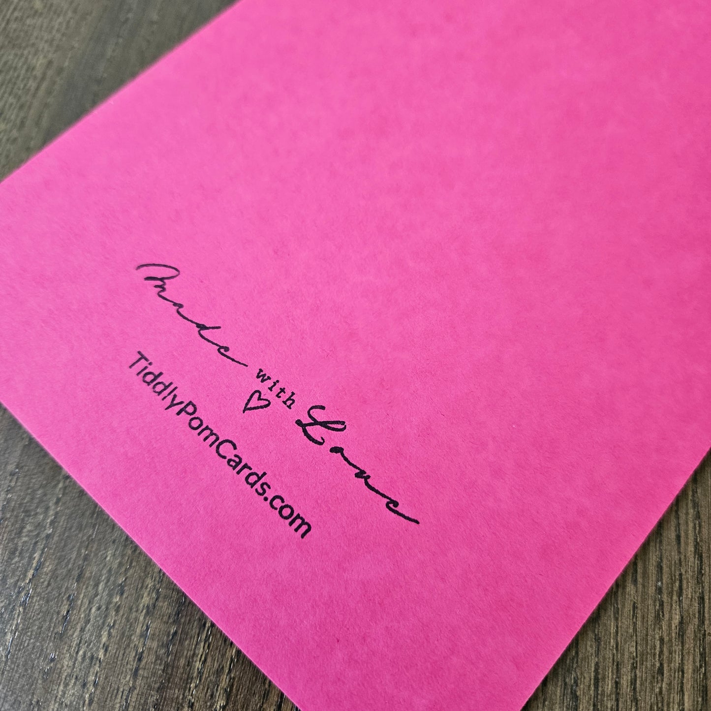 a handmade 5x7 birthday card featuring a vibrant watercolor floral split panel design and printed heartfelt sentiments, finished with a crisp black mat and bright pink cardstock frame. Tiddly Pom Cards