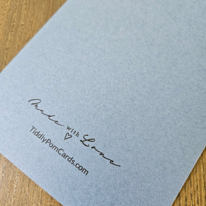Inside panel of the 5x7 card displaying a printed birthday message in crisp black ink with Happy Birthday Dad in blue script, accented by a single blue heart outline in the lower right corner.