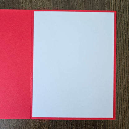handmade A2 birthday card featuring a classic black ink storybook sketch illustration of Winnie the Pooh wearing a striped party hat while sitting with a wrapped gift box and a balloon, printed with the sentiment Happy Birthday!, finished with a stitched edge border, black mat, and red cardstock