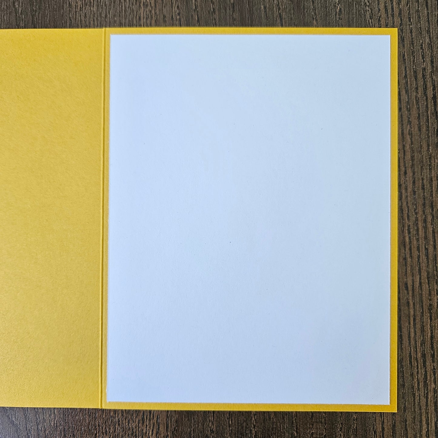 a handmade A2 birthday card featuring a classic black ink storybook sketch illustration of Winnie the Pooh sitting on the grass next to a large honey pot with a balloon floating behind him, printed with the sentiment Sweet little smiles on your birthday, finished with a stitched edge border, red mat, and bright yellow cardstock frame