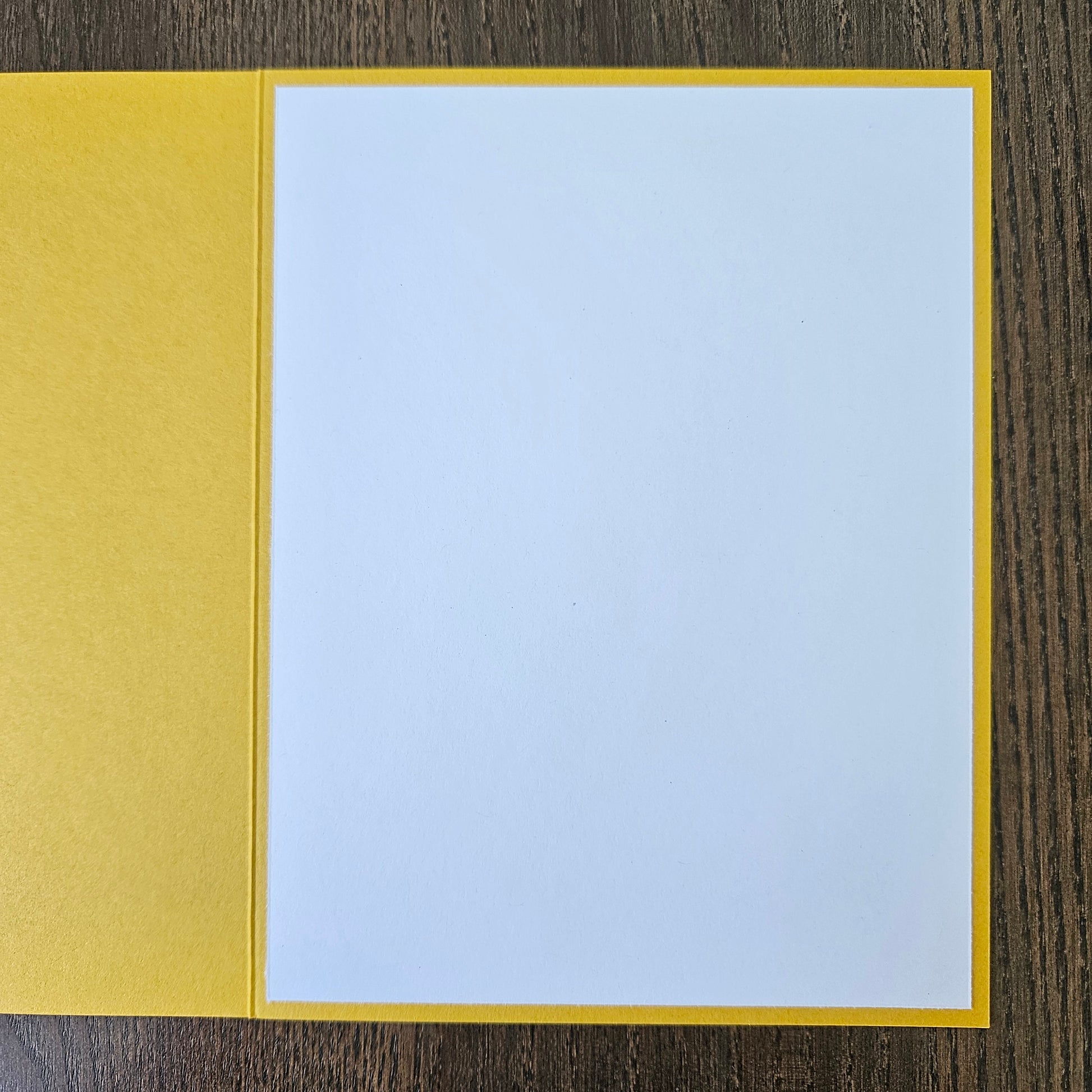 a handmade A2 birthday card featuring a classic black ink storybook sketch illustration of Winnie the Pooh sitting on the grass next to a large honey pot with a balloon floating behind him, printed with the sentiment Sweet little smiles on your birthday, finished with a stitched edge border, red mat, and bright yellow cardstock frame