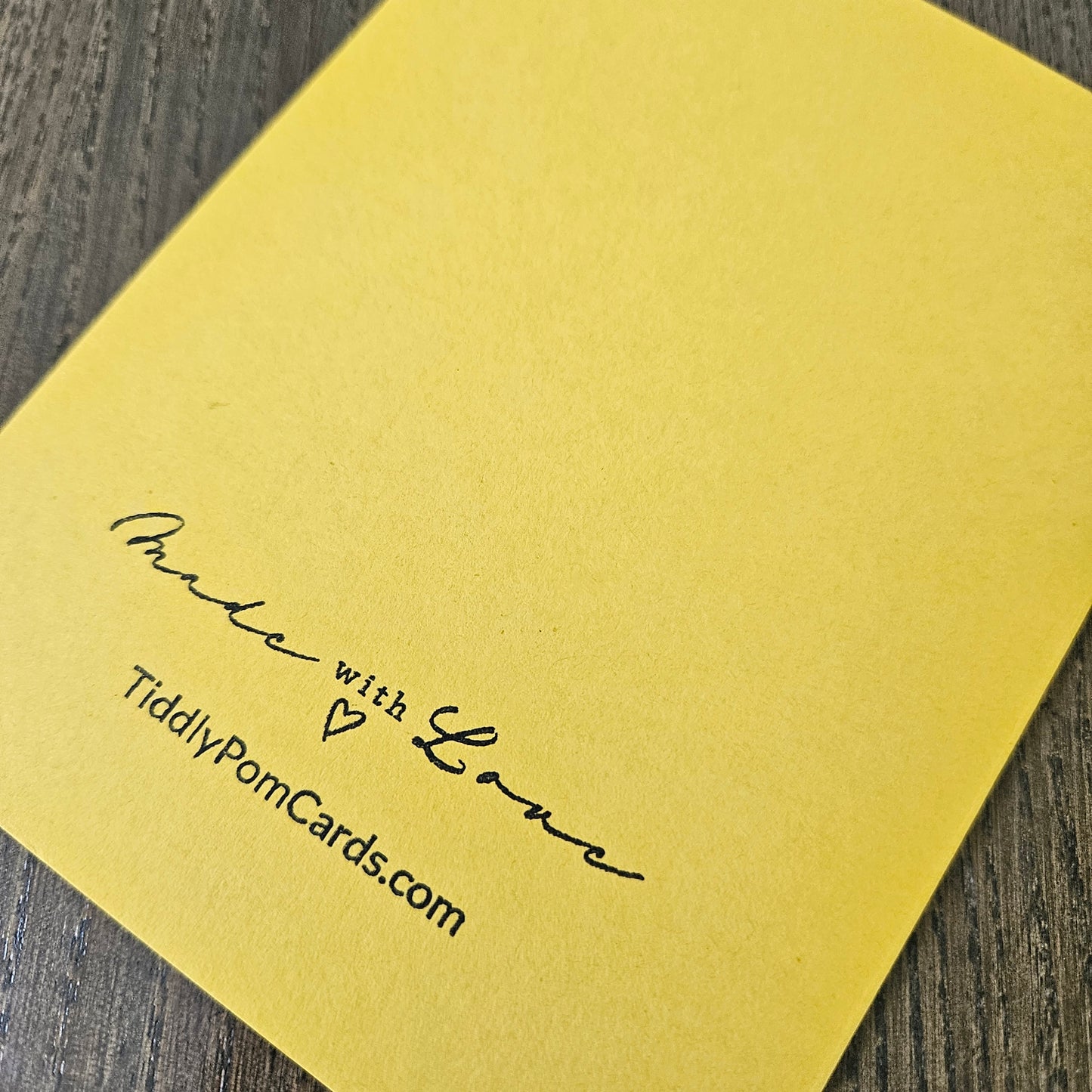 a handmade A2 birthday card featuring a classic black ink storybook sketch illustration of Winnie the Pooh sitting on the grass next to a large honey pot with a balloon floating behind him, printed with the sentiment Sweet little smiles on your birthday, finished with a stitched edge border, red mat, and bright yellow cardstock frame
