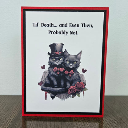 Front of a handmade Gothic Valentine's Day card featuring an illustration of two black cats with a bold Til Death banner accent framed in layered dark cardstock.
