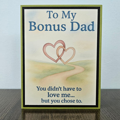 Front of a handmade A2 birthday card for bonus dad with sage green and black borders featuring text reading To My Bonus Dad You didn't have to love me but you chose to.