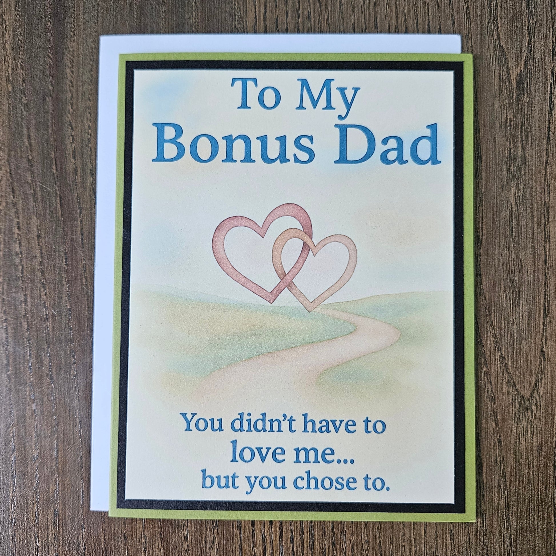 Front of a handmade A2 birthday card for bonus dad with sage green and black borders featuring text reading To My Bonus Dad You didn't have to love me but you chose to.
