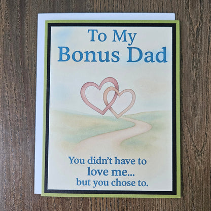 Front of a handmade A2 birthday card for bonus dad with sage green and black borders featuring text reading To My Bonus Dad You didn't have to love me but you chose to.