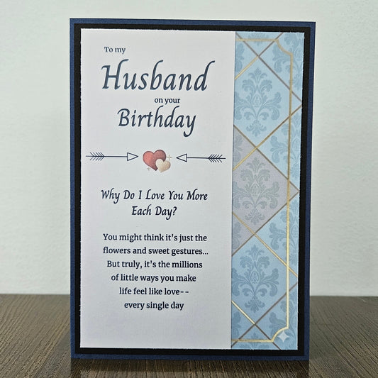 Front of a handmade A2 birthday card for husband featuring a blue and gold damask pattern framed in black with text reading Happy Birthday to My Amazing Husband.