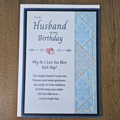 Front of a handmade A2 birthday card for husband featuring a blue and gold damask pattern framed in black with text reading Happy Birthday to My Amazing Husband.