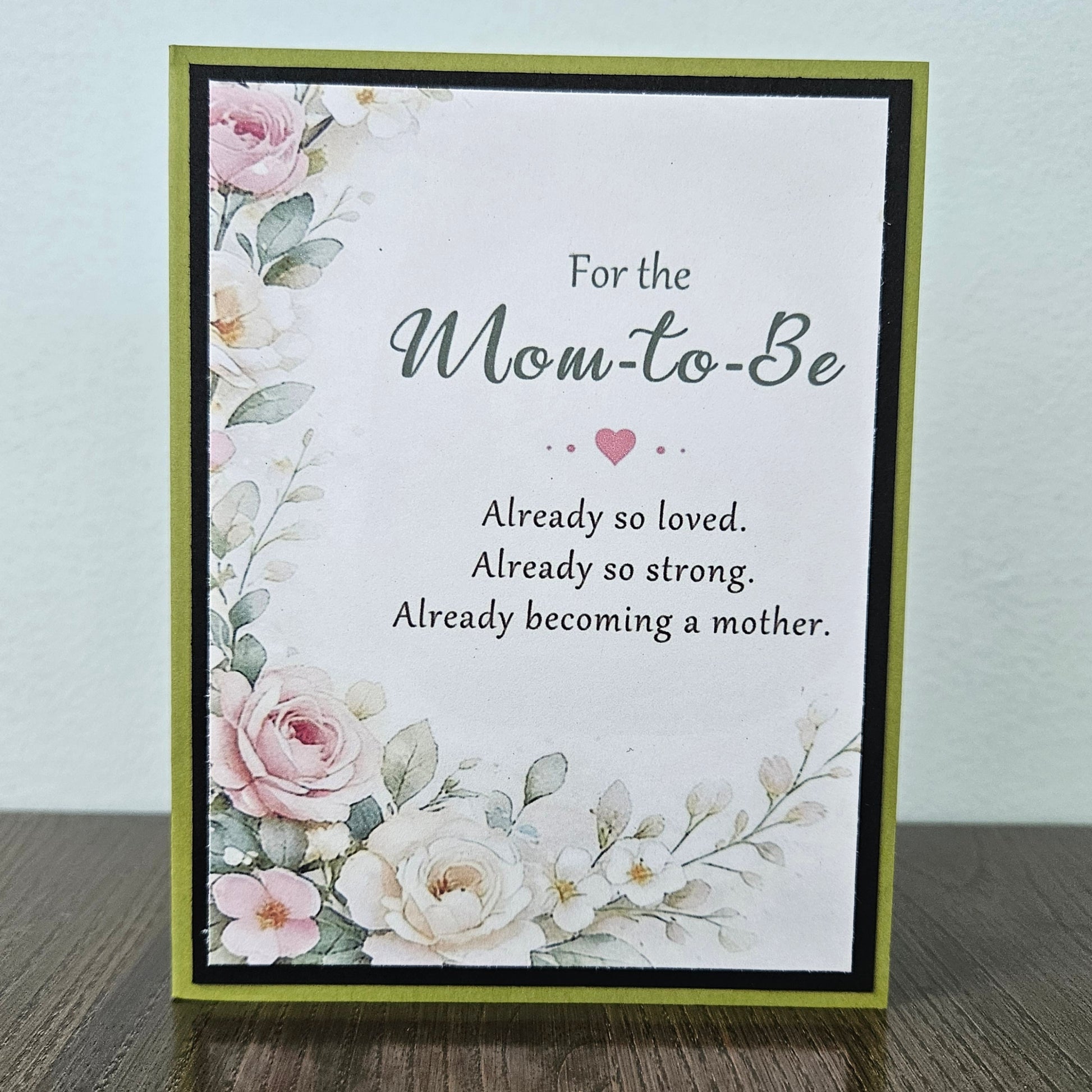 A handmade greeting card with a floral design and the text 'For the Mom-to-Be Already so loved. Already so strong.