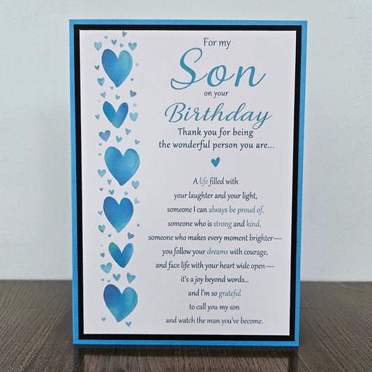 Front of a handmade 5x7 birthday card for son featuring a vertical row of watercolor blue hearts framed in black and blue with a detailed birthday poem.