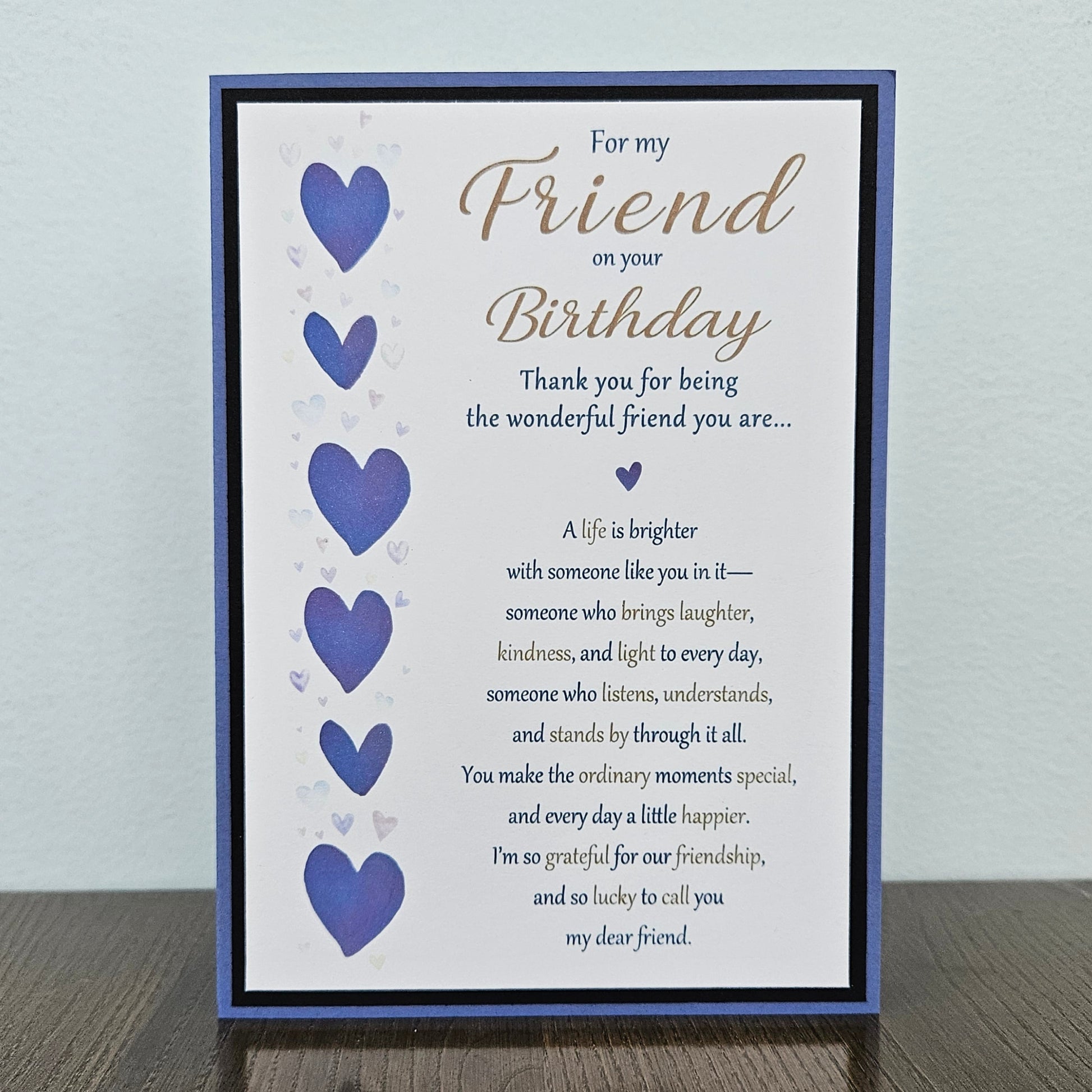 Front of a handmade 5x7 birthday card for friend featuring a vertical row of watercolor purple hearts framed in black and purple with a detailed birthday poem.