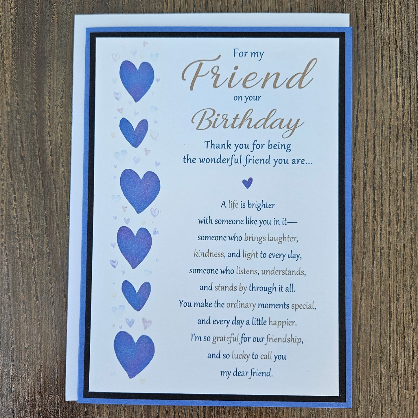 Front of a handmade 5x7 birthday card for friend featuring a vertical row of watercolor purple hearts framed in black and purple with a detailed birthday poem.