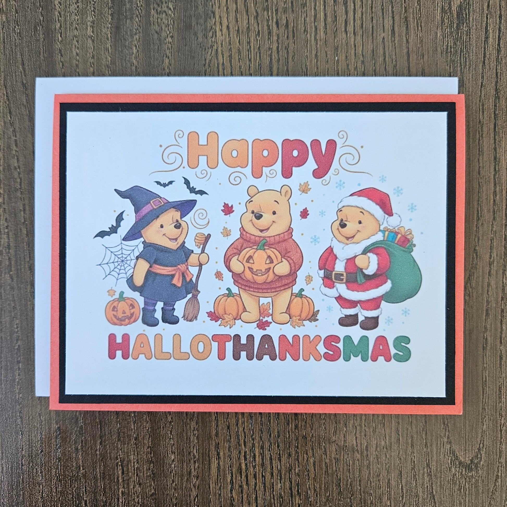 A square Halloween greeting card featuring Winnie the Pooh and friends in costumes, with the text 'Happy HALLOTHANKSMAS' on a light wood background.