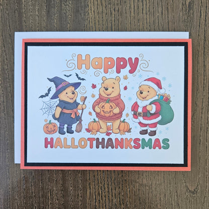 A square Halloween greeting card featuring Winnie the Pooh and friends in costumes, with the text 'Happy HALLOTHANKSMAS' on a light wood background.