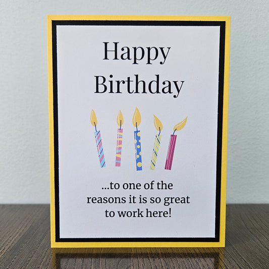 Front of a handmade A2 coworker birthday card featuring colorful birthday candles framed by black and yellow cardstock with text reading Happy Birthday to one of the reasons it is so great to work here.