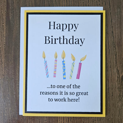 Front of a handmade A2 coworker birthday card featuring colorful birthday candles framed by black and yellow cardstock with text reading Happy Birthday to one of the reasons it is so great to work here.