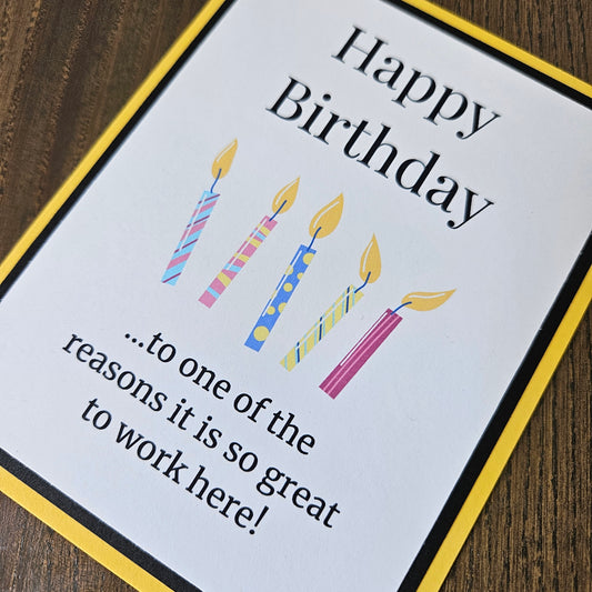 Front of a handmade A2 coworker birthday card featuring colorful birthday candles framed by black and yellow cardstock with text reading Happy Birthday to one of the reasons it is so great to work here.