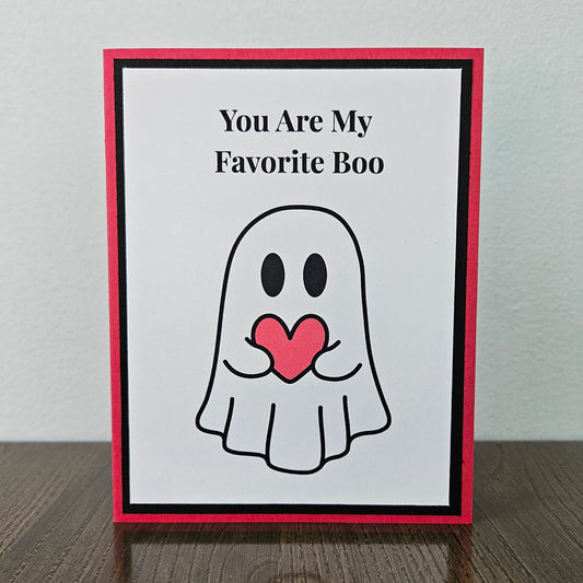 Front of a handmade A2 love card featuring a cute ghost holding a red heart framed in black and red with text reading You Are My Favorite Boo.