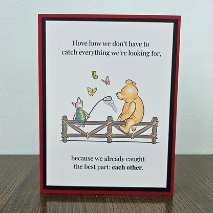 Handmade Winnie the Pooh friendship card featuring a classic storybook illustration of Pooh Bear and Piglet sitting together on a rustic wooden fence watching butterflies, finished with layered cardstock frames.