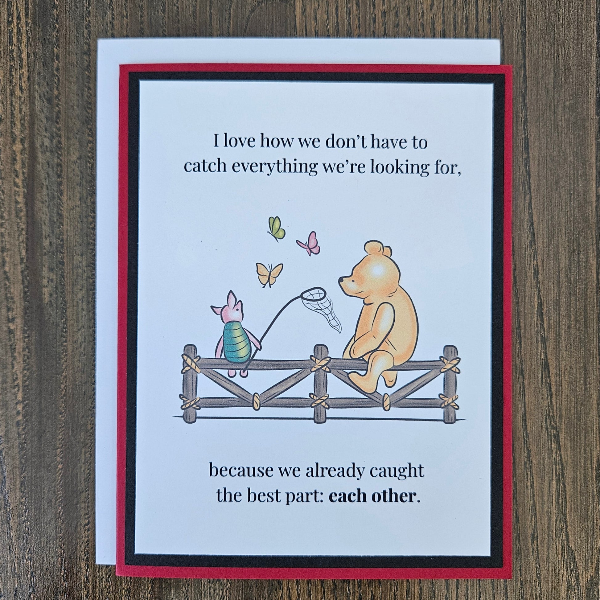 Handmade Winnie the Pooh friendship card featuring a classic storybook illustration of Pooh Bear and Piglet sitting together on a rustic wooden fence watching butterflies, finished with layered cardstock frames.