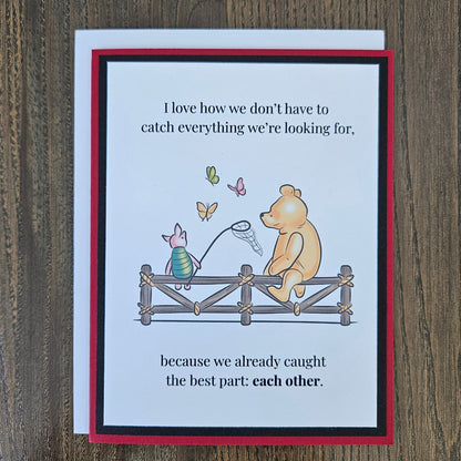 Handmade Winnie the Pooh friendship card featuring a classic storybook illustration of Pooh Bear and Piglet sitting together on a rustic wooden fence watching butterflies, finished with layered cardstock frames.