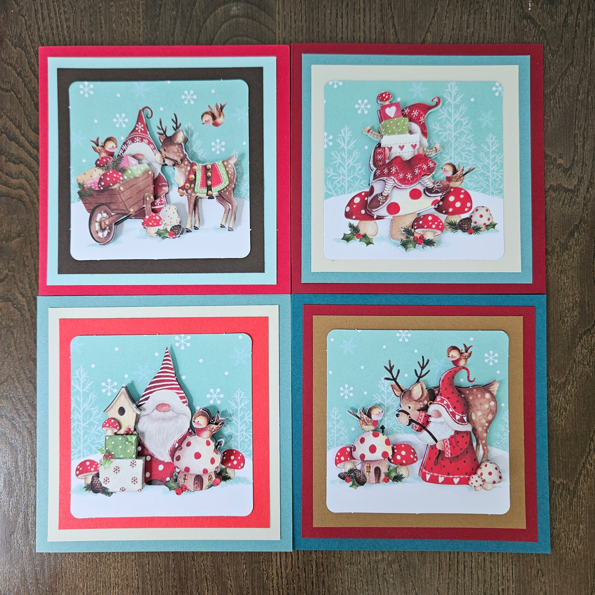 Front and inside views of a 4-card set of handmade 5.5x5.5 square Christmas cards featuring 3D decoupage gnomes, reindeer, birds, and toadstools.