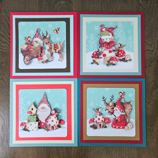 Front and inside views of a 4-card set of handmade 5.5x5.5 square Christmas cards featuring 3D decoupage gnomes, reindeer, birds, and toadstools.