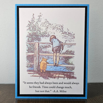 A square greeting card featuring a Winnie the Pooh illustration of Pooh and Tigger looking at water, with a quote from A.A.