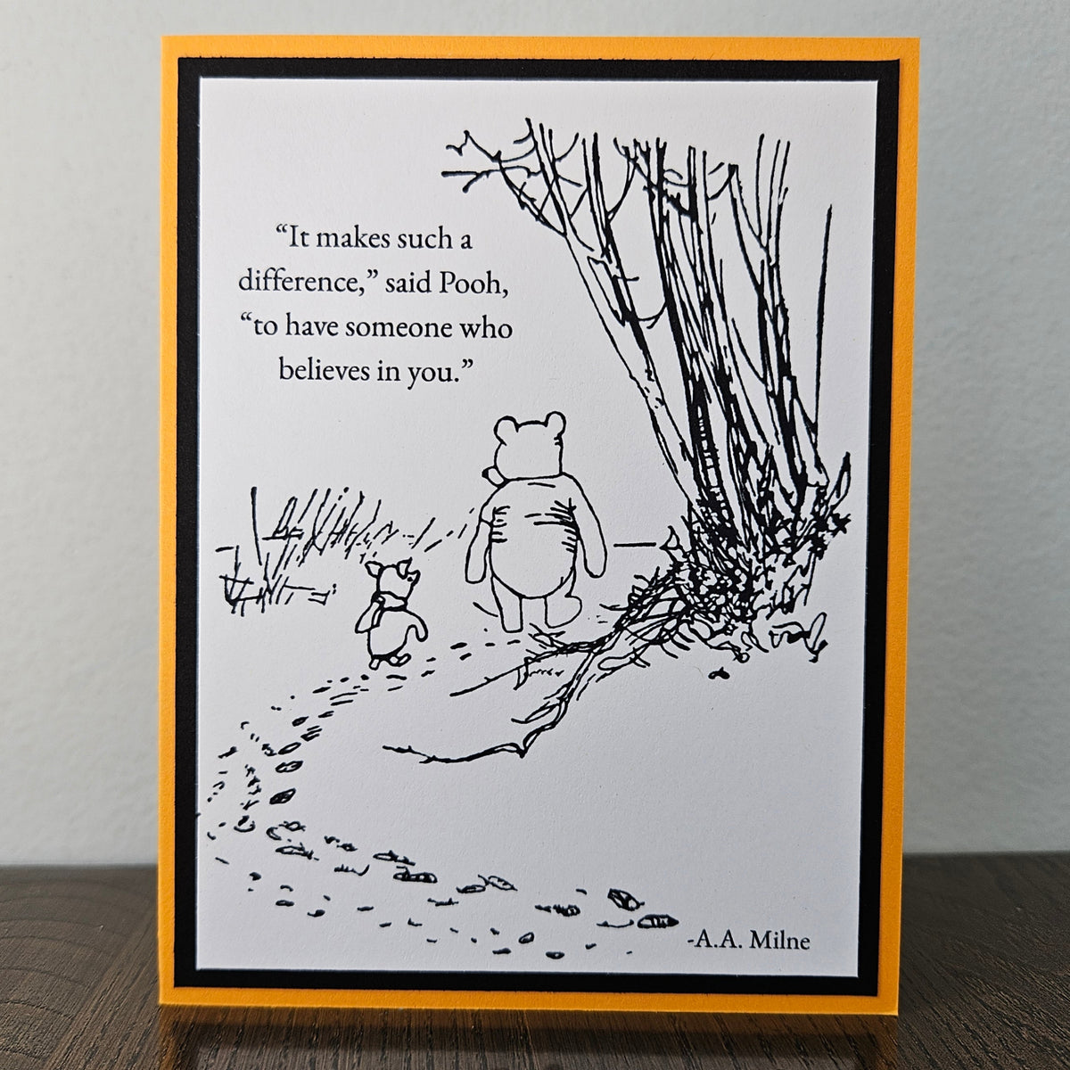 Front of a handmade A2 Winnie the Pooh friendship card featuring classic Pooh and Piglet walking together with the quote It makes such a difference to have someone who believes in you.