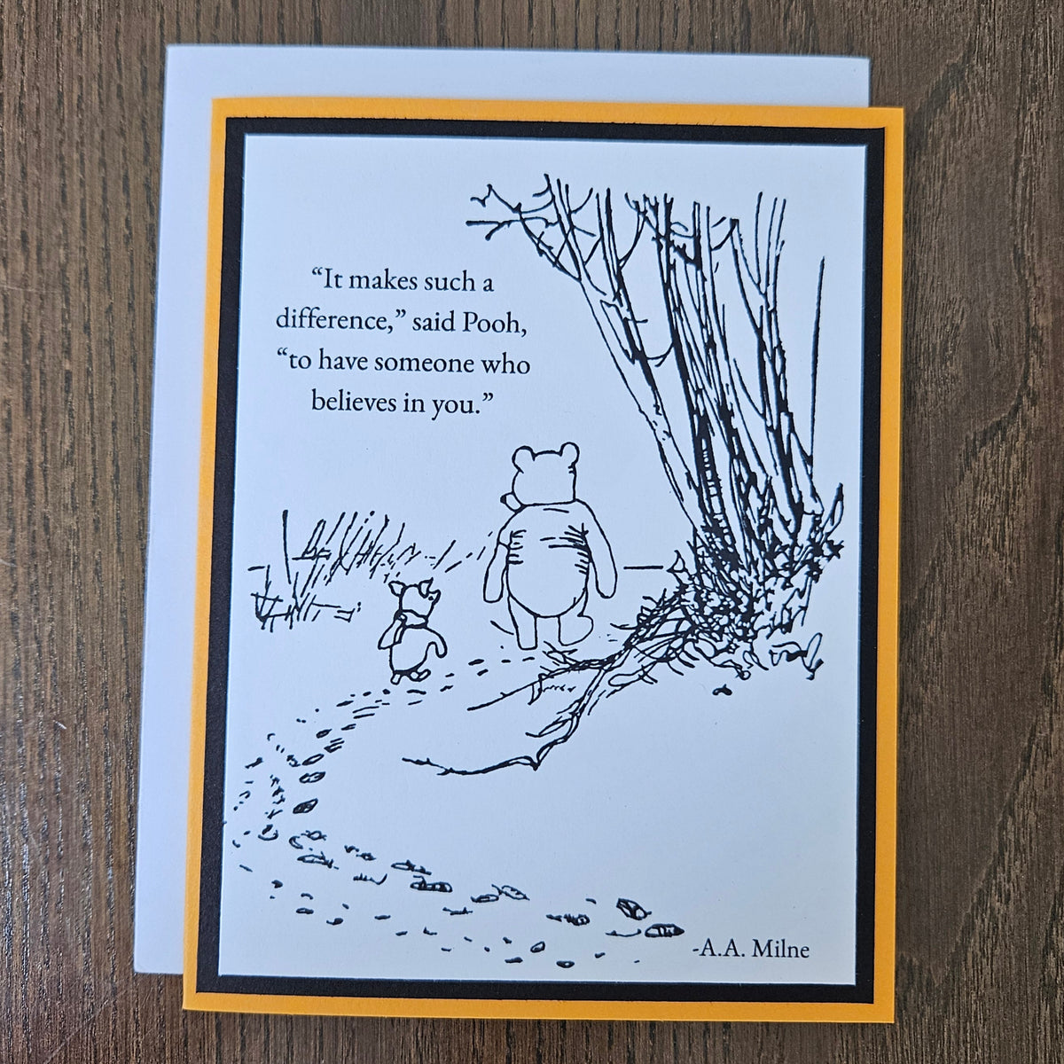 Front of a handmade A2 Winnie the Pooh friendship card featuring classic Pooh and Piglet walking together with the quote It makes such a difference to have someone who believes in you.