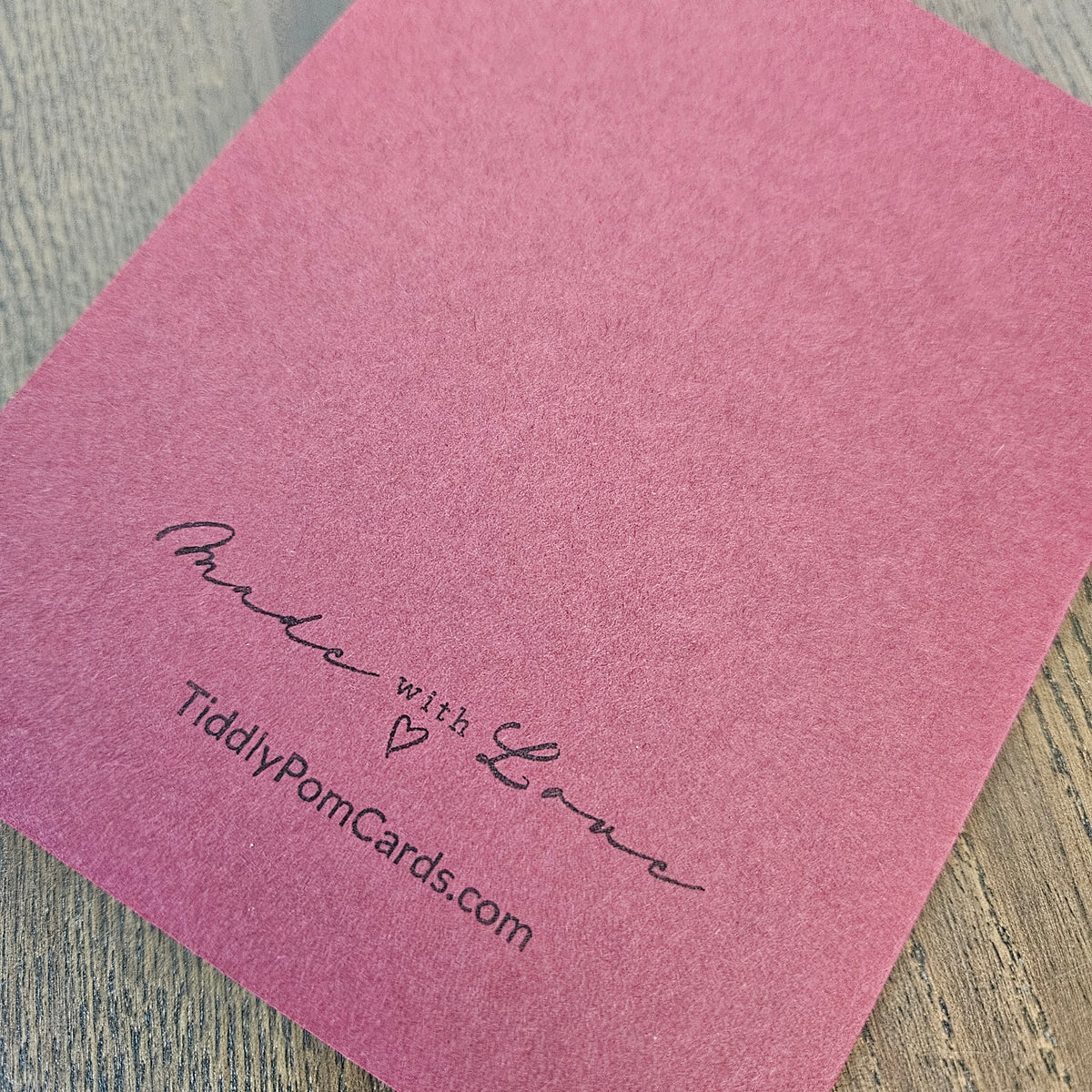 Burgundy handmade card back with Made with Love and TiddlyPomCards.com branding
