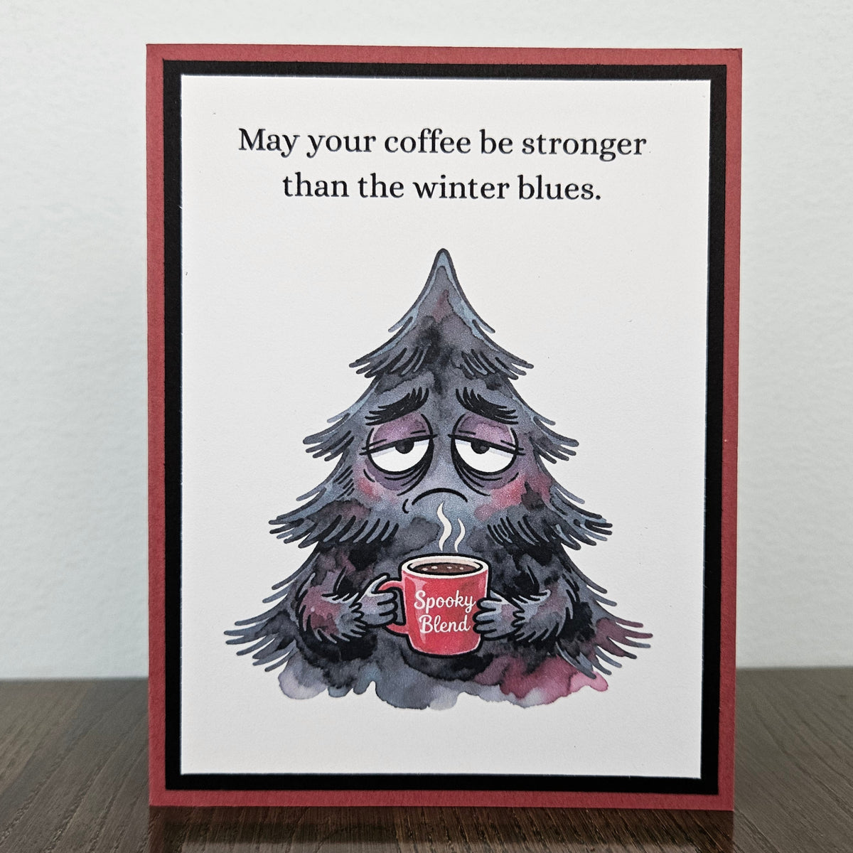 Handmade funny winter card with grumpy evergreen tree holding a Spooky Blend coffee mug
