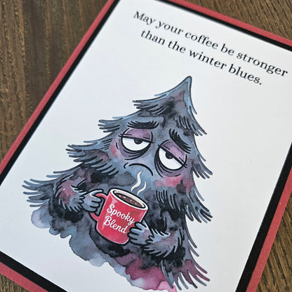 Close-up of grumpy evergreen tree holding steaming coffee beneath winter blues sentiment