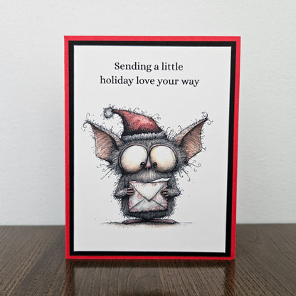 Handmade Christmas card with Santa-hat bat holding envelope and Sending a little holiday love your way message