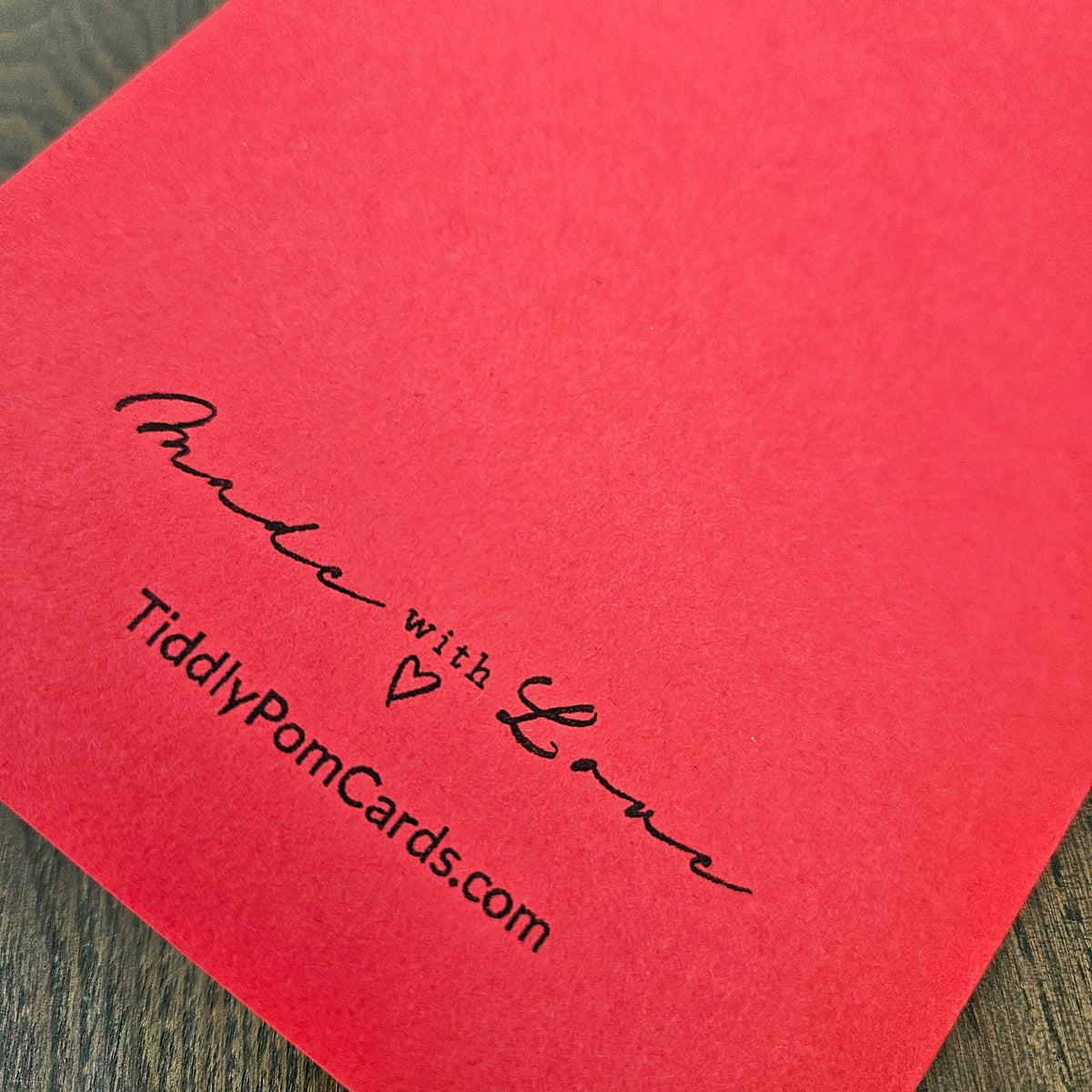 Red card back with Tiddly Pom Cards Made with Love branding