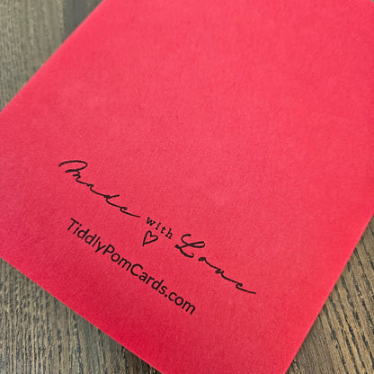 Red back of handmade holiday card with Tiddly Pom Cards branding
