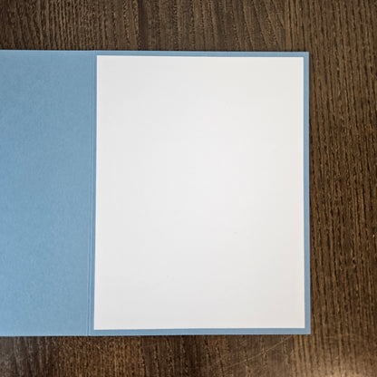 Blank white interior of the light-blue A2 Winter Solstice greeting card, ready for a handwritten message.
