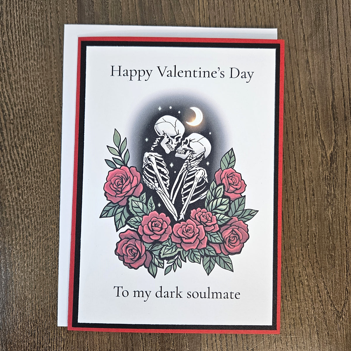 Full gothic dark soulmate Valentine card with its coordinating envelope on a wooden surface.
