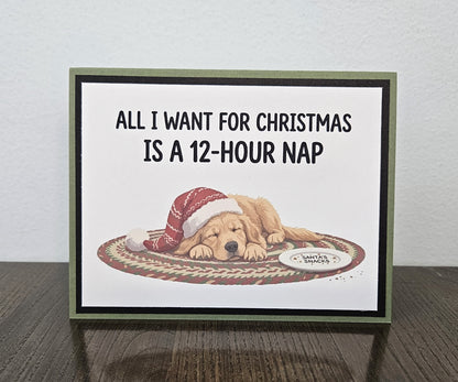 Landscape handmade Christmas card with a sleeping dog in a Santa hat and the words All I want for Christmas is a 12-hour nap.